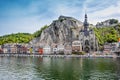 The historic town of Dinant with the Belgian flag and the citadelle on the rock and Collegiate Church of Notre-Dame at the Meuse Royalty Free Stock Photo