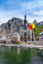 The historic town of Dinant with the Belgian flag and the citadelle on the rock and Collegiate Church of Notre-Dame at the Meuse Royalty Free Stock Photo