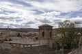 a historic town with a tower and old buildings, set against a backdrop of fluffy clouds and nature Royalty Free Stock Photo