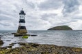 Historic Trwyn Du Penmon Lighthouse on the shore in Penmon, Wales