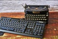 Historic typewriter and modern keyboard that show the progress of the last 100 years