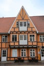 Historic and typical orange and wooden painted timbered building with white windows and doors in the city centre, Aalborg, Denmark Royalty Free Stock Photo