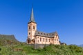 Historic Vagan Kirke stands with its distinctive architecture against a clear blue sky in Lofoten, Norway,