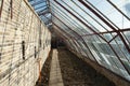 Historic wall glasshouse rebuilt from authentic bricks and iron