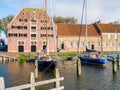 Historic warehouse and sailboats in east harbour of old town of Enkhuizen, North Holland, Netherlands