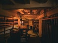 The hull of HMS Victory. A dim lantern lighting the dark room with a musket rack on the right