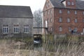 Historic water mill.Old mill meal. Spring.Fragments of buildings and gateway. Royalty Free Stock Photo