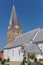 Historic white church with brick tower in Mogeltonder