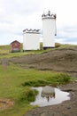 Historic white painted crenelated lighthouse