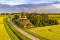 Historic windmill at a farm in agricultural landscape