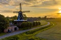 Historic windmill at a farm in agricultural landscape