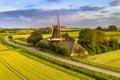 Historic windmill at a farm in agricultural landscape
