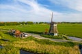 Historic windmill in the middle of fields near the Volendam village, North Holland