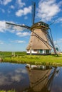 A historic windmill with reflection on the water. Royalty Free Stock Photo