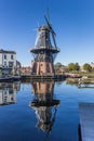 Historic windmill with reflection in the water in Haarlem Royalty Free Stock Photo