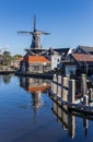 Historic windmill with reflection in the water in Haarlem Royalty Free Stock Photo