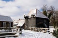 Historic wooden building, water mill in dutch rural landscape with snow. Winter scenic locations architecture. Tourism travel dest Royalty Free Stock Photo