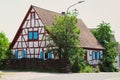 Historic wooden house with bright blue shutters