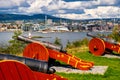 Historic XIX century Napoleonic war cannons battery on Hovedoya island of Oslofjord harbor with metropolitan Oslo, Norway in