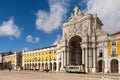 Historic yellow tram in downtown Lisbon at the Rua Augusta city gate and Commercial Square