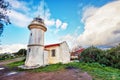 Historical Aegean lighthouse against a blue sky and clouds background Royalty Free Stock Photo