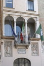 Historical balcony with flags, Crema, Italy