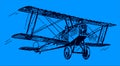 Antique biplane aircraft flying under a dark blue sky Royalty Free Stock Photo