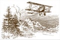 Historical biplane aircraft flying over a mountaineous region with trees
