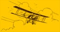 Historical biplane flying out of the clouds on a yellow-orange background