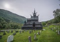 Historical Borgund stave church in Norway with surrounding cemetery.
