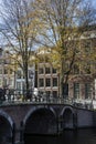 Historical brown bridge with bikes over the canal in autumn Royalty Free Stock Photo