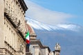 Historical building in Catania, Sicily, Italy with waving Italian flag. In the background cupola of famous Saint Agatha Cathedral Royalty Free Stock Photo