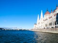 Historical building of Hungarian Parliament on Danube River Embankment in Budapest. Sunny day shot with clear blue sky. Royalty Free Stock Photo