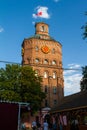 Historical building of water tower shine in evening sun, flag waving on old symbol of the city, Vinnytsia, Ukraine