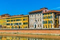 Historical buildings stretched alongside river Arno in the historical center of the italian city Pisa....IMAGE Royalty Free Stock Photo