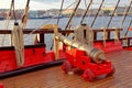Historical cannon of an old wooden sailboat. Details deck of the ship. Royalty Free Stock Photo