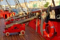 Historical cannon of an old wooden sailboat. Details deck of the ship. Royalty Free Stock Photo