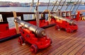 Historical cannon of an old wooden sailboat. Details deck of the ship. Royalty Free Stock Photo