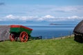 A historical cart in the Skye museum of island life with ancient houses and sea in the background in Northern Scotland Royalty Free Stock Photo