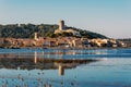 Historical center of Gruissan town with Barberousse Tower in top seen from the opposite side of the pond. Occitanie, France