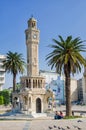 Historical clock tower, mosque and palm trees in Konak Square in the city of Izmir, Turkey Royalty Free Stock Photo