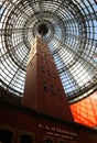 Historical Coop`s  Shot Tower, encased by the Melbourne Central 84 m-high conical glass roof. Royalty Free Stock Photo