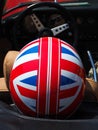 Historical Gran Prix. Helmet with English flag in a historic car