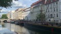 Historical harbor of Berlin with Fischerinsel Isle. People walking along the street. Old boats and ships