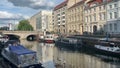 Historical harbor of Berlin with Fischerinsel Isle. People walking along the street. Old boats and ships