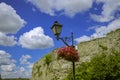 Historical heritage site local urban landmark view of old city street with lantern and stone castle wall background in clear Royalty Free Stock Photo