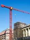 Historical house facade restoration and roof repair using scaffolding and tower crane Royalty Free Stock Photo