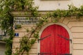 Historical house with red door and green ivy on the wall Royalty Free Stock Photo