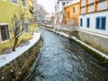 Historical houses and castle landmark statue river winter season snow in Cesky Krumlov. Czech Republic Royalty Free Stock Photo