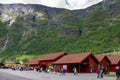 Historical houses of Flam, Norway with tourists walking by